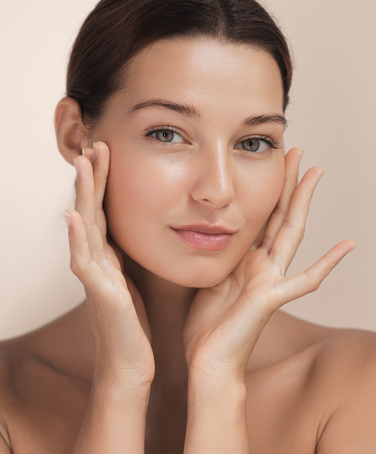 Woman gently touching her face, natural beauty.