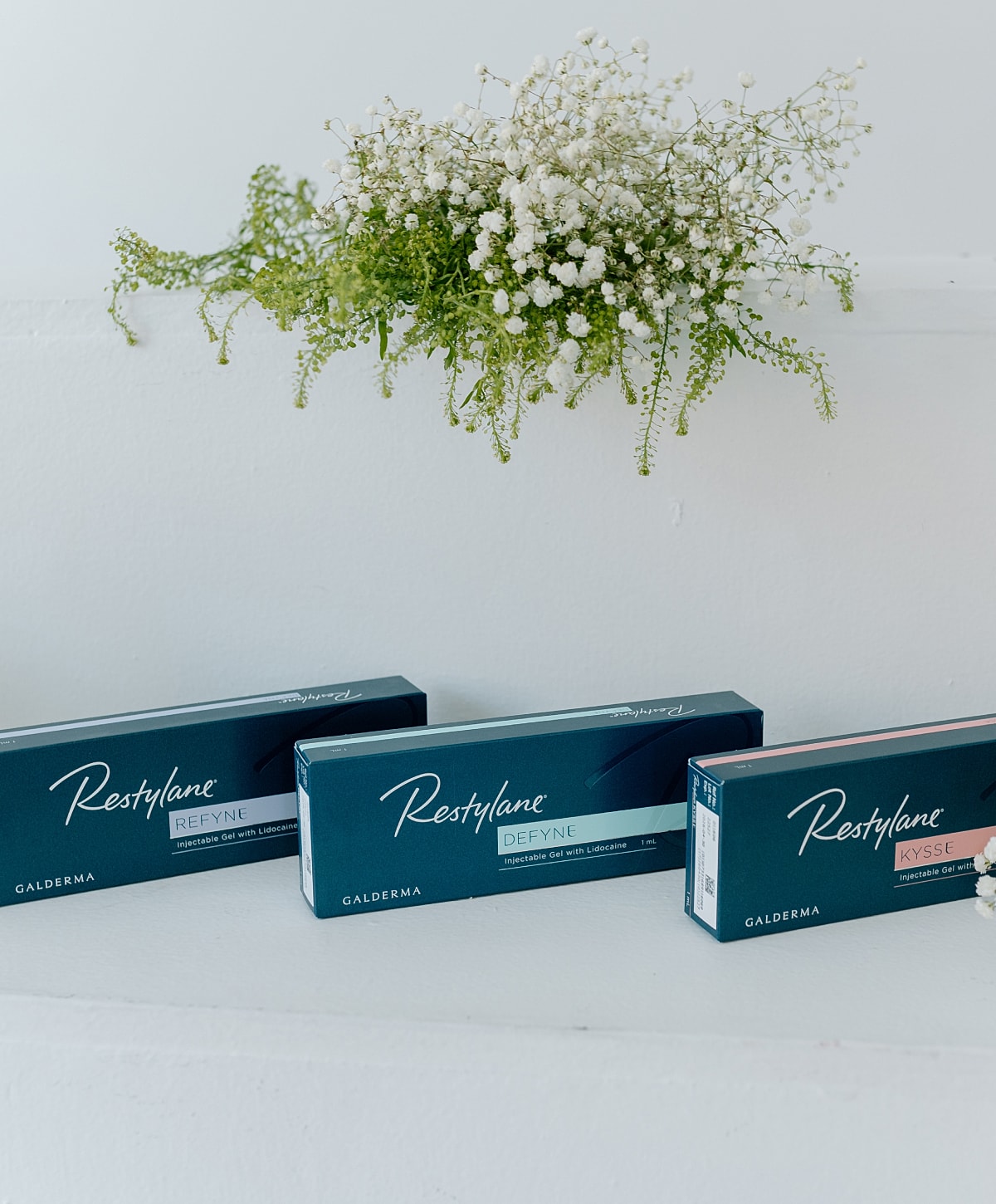 Restylane products with floral arrangement backdrop