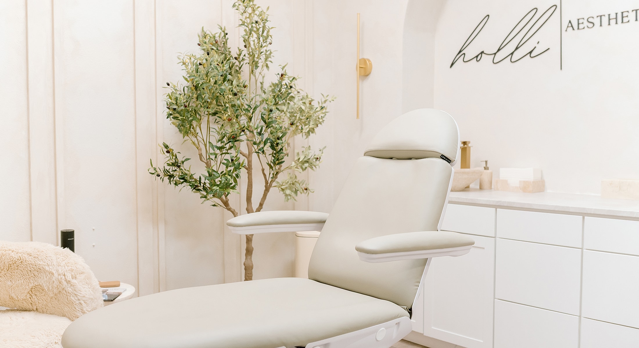 Aesthetic treatment room with reclined chair.